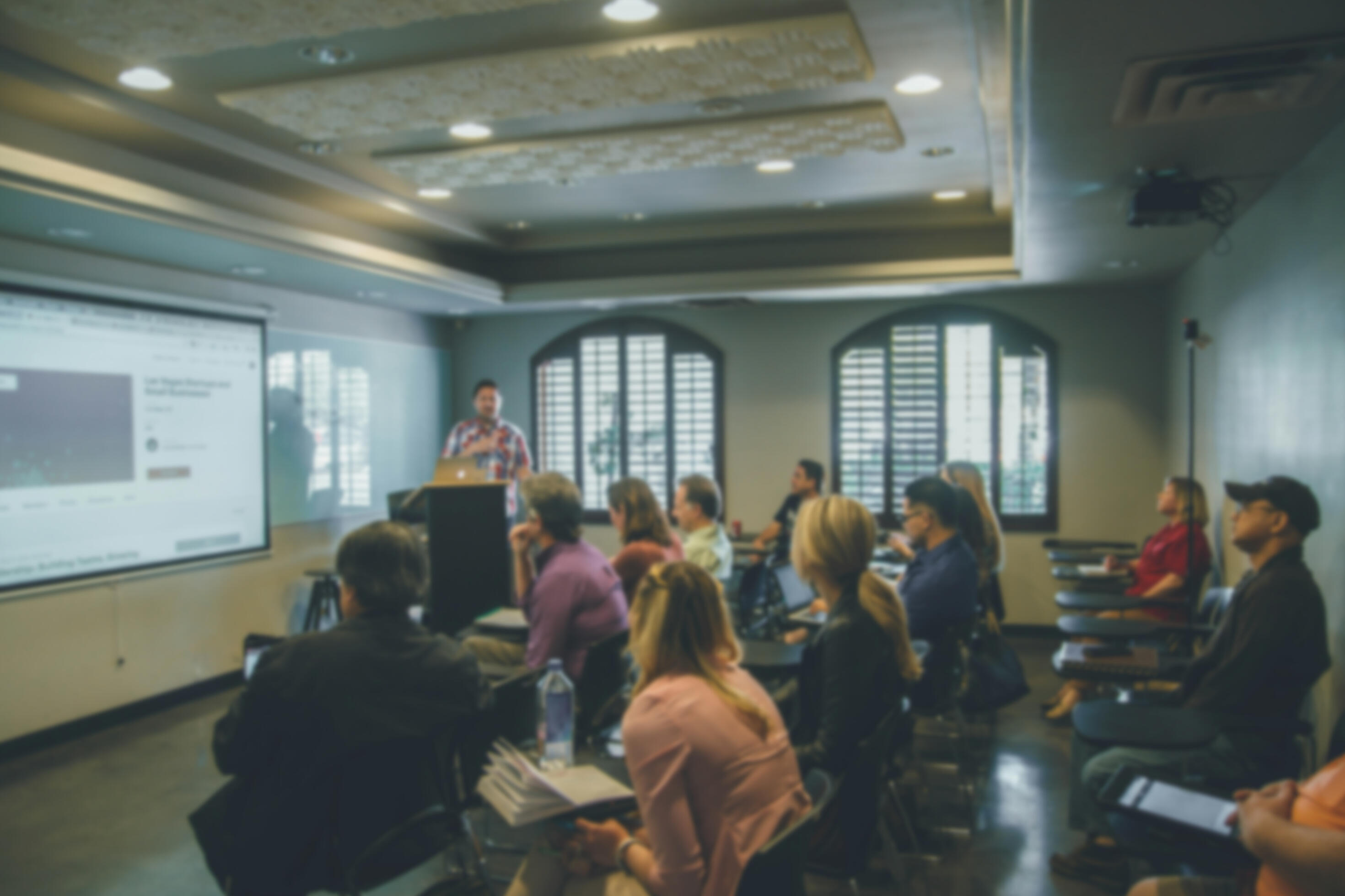 Instructor teaching an AI chatbots class to a room of adults.